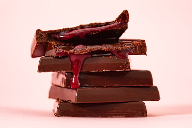 A stack of chocolate bars with syrup on topDescription automatically generated