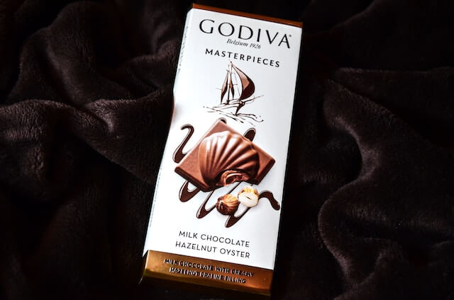 A chocolate bar on a black cloth

Description automatically generated