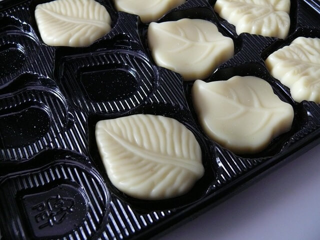 A tray of white chocolatesDescription automatically generated