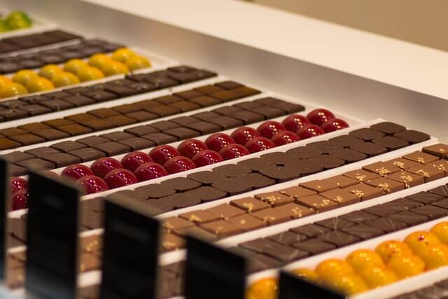 A row of chocolates in rowsDescription automatically generated