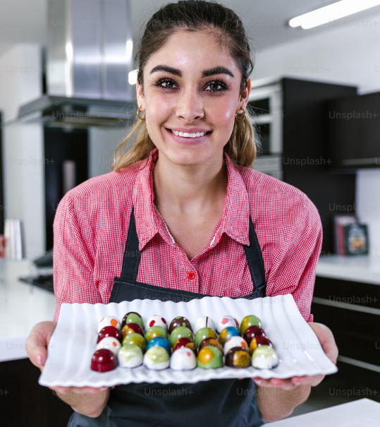 A person holding a plate of candy

Description automatically generated