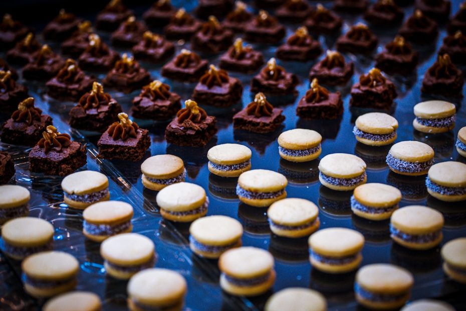 a table topped with lots of cookies covered in frosting